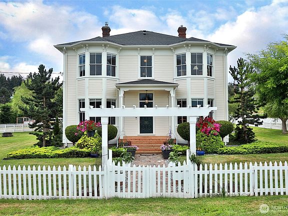 Front elevation of the 1894 John Gould residence, symmetric Italianate Victorian with bay windows on both floors and central portico entry